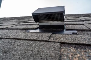 Attic vent on an asphalt shingle roof
